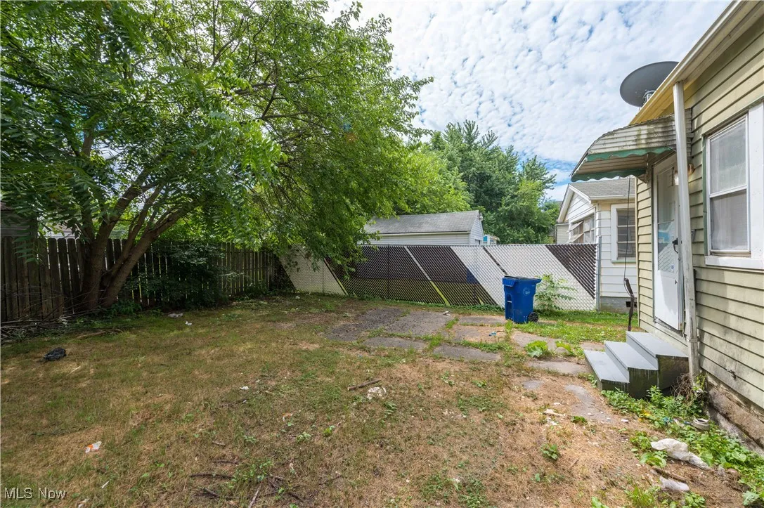 Fenced backyard with entry steps