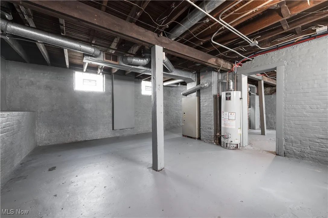 Basement featuring gas water heater and heating unit