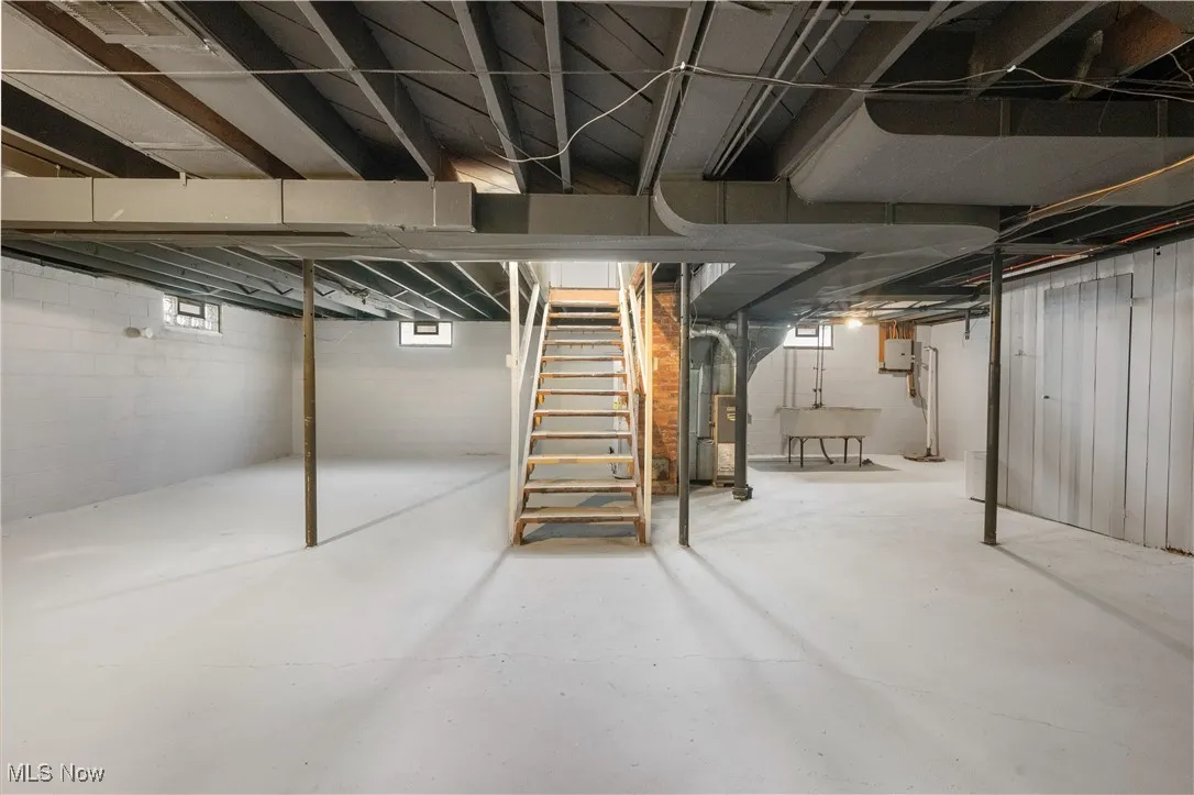 Below grade area featuring stairs and drainage system