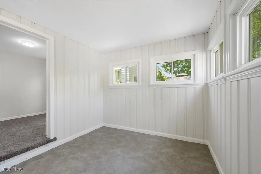 Spare room with carpet and baseboards