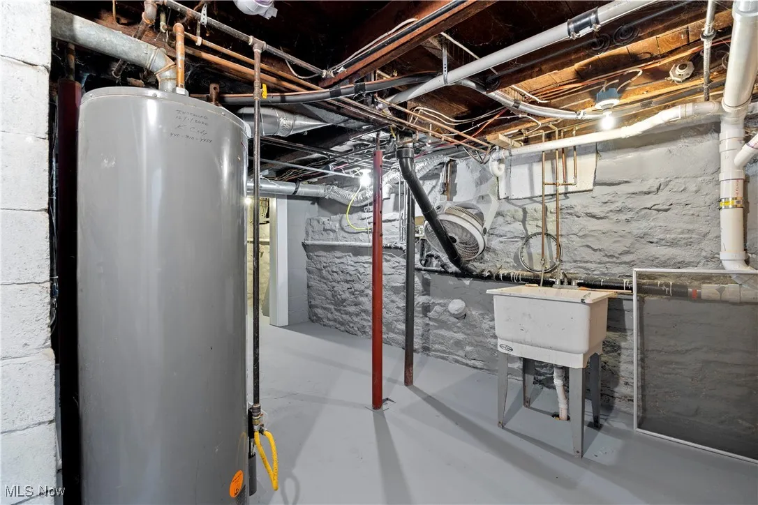 Unfinished below grade area featuring gas water heater