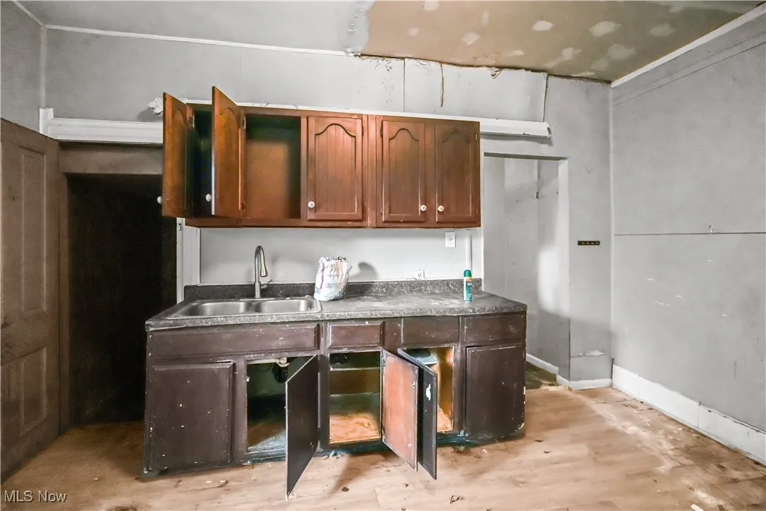 Kitchen featuring light wood-style floors and dark countertops
