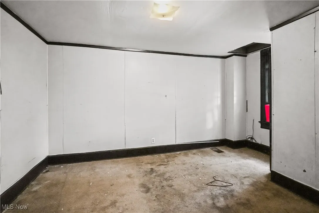 Unfurnished room with unfinished concrete floors