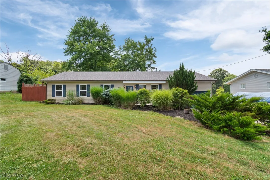 Single story home featuring a front lawn