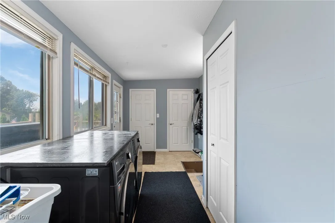 Kitchen with dark cabinets and light tile patterned floors