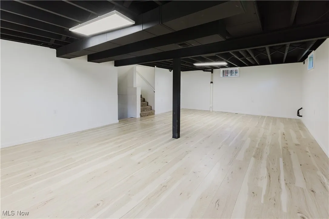 Basement featuring stairway and wood finished floors