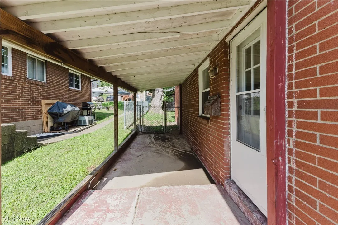 View of patio / terrace with grilling area and a gate