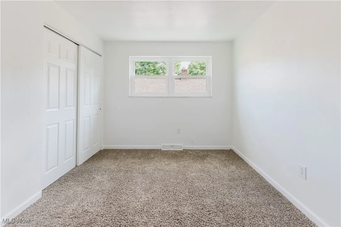 Unfurnished bedroom featuring carpet floors and a closet