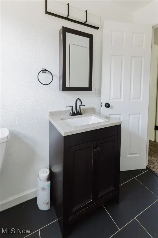 Bathroom featuring vanity and tile patterned floors