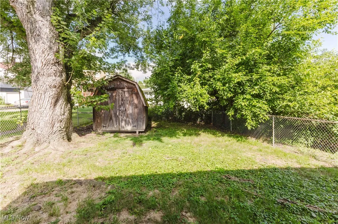Fenced backyard with a storage unit