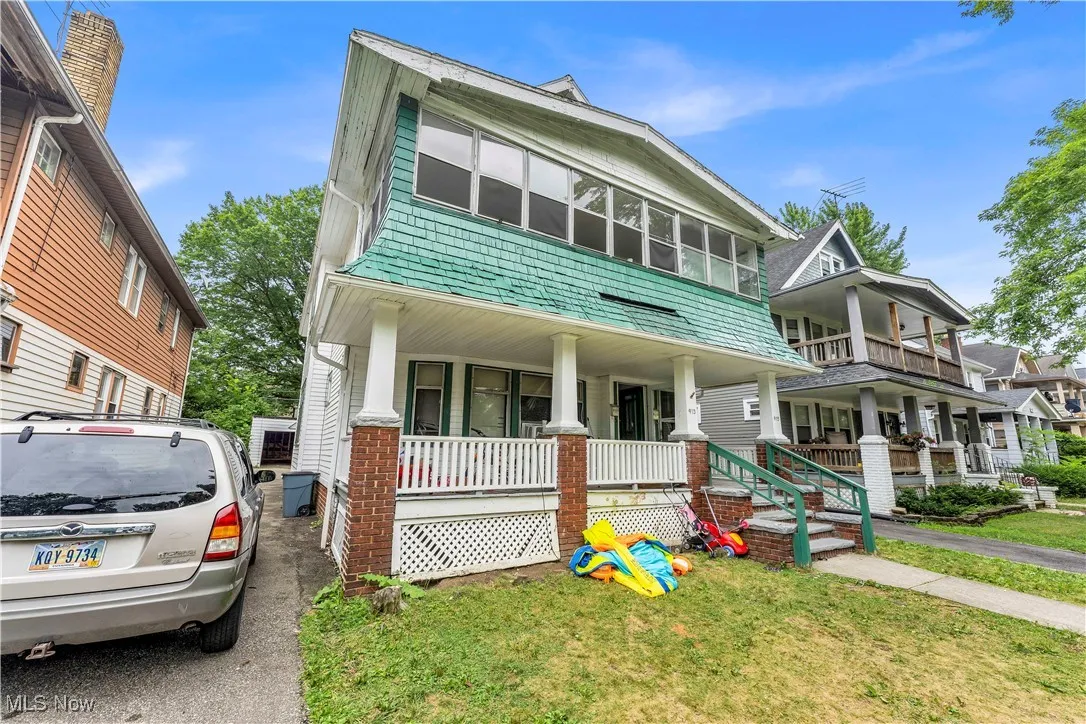 View of front facade with a porch and a front lawn