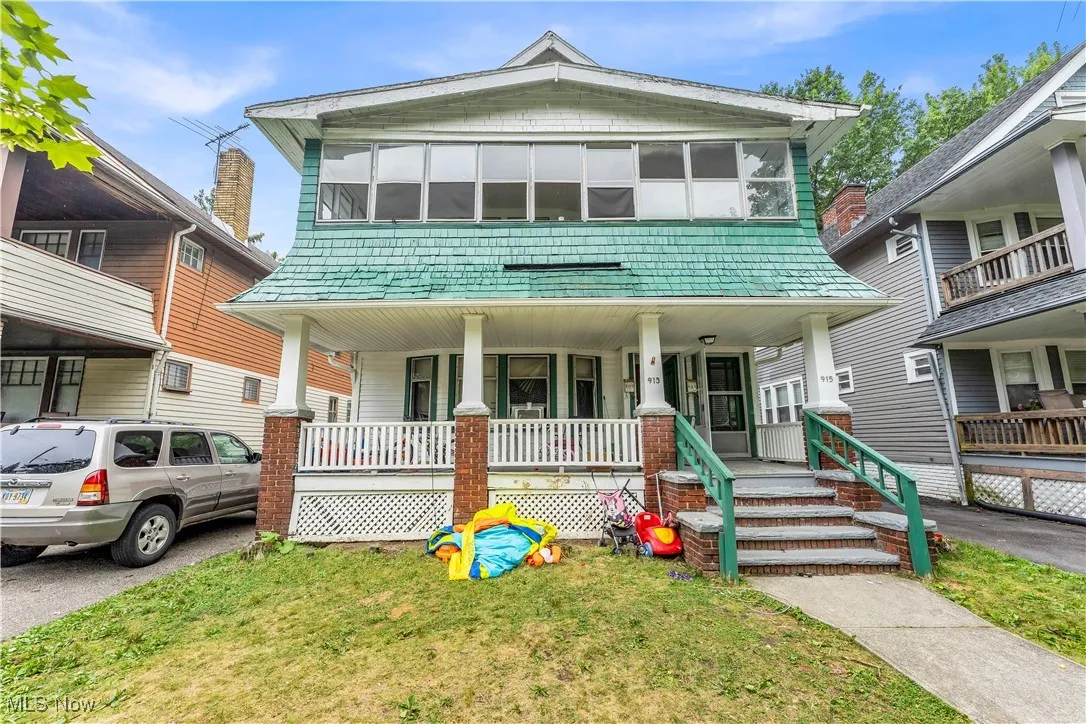 View of front of house with a porch and a front lawn