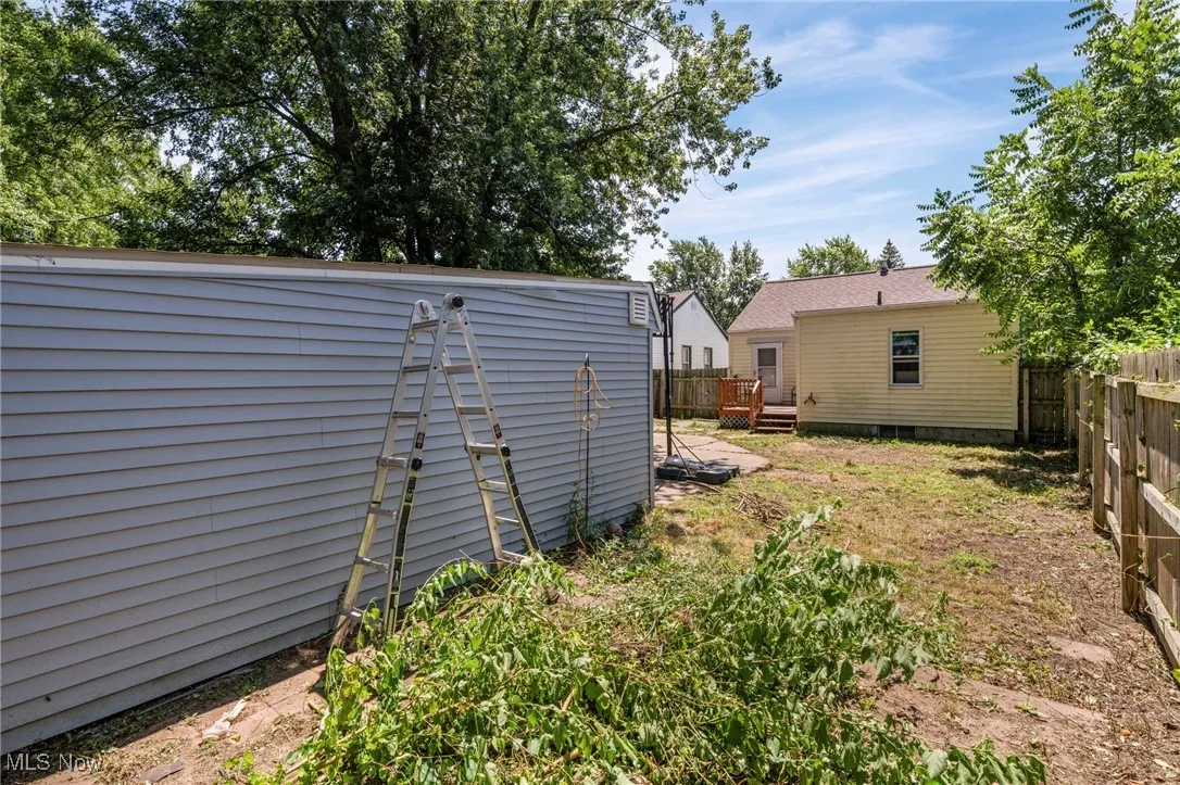 View of yard with a deck and a storage shed