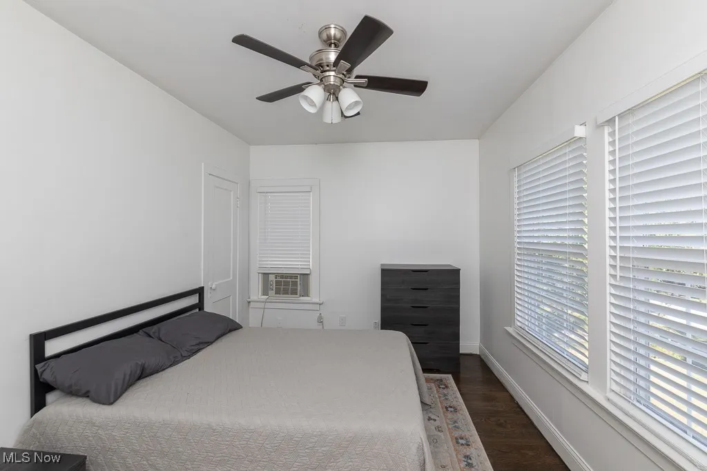 Bedroom featuring dark wood-type flooring and ceiling fan