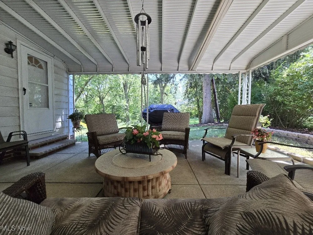 View of patio with outdoor lounge area and grilling area