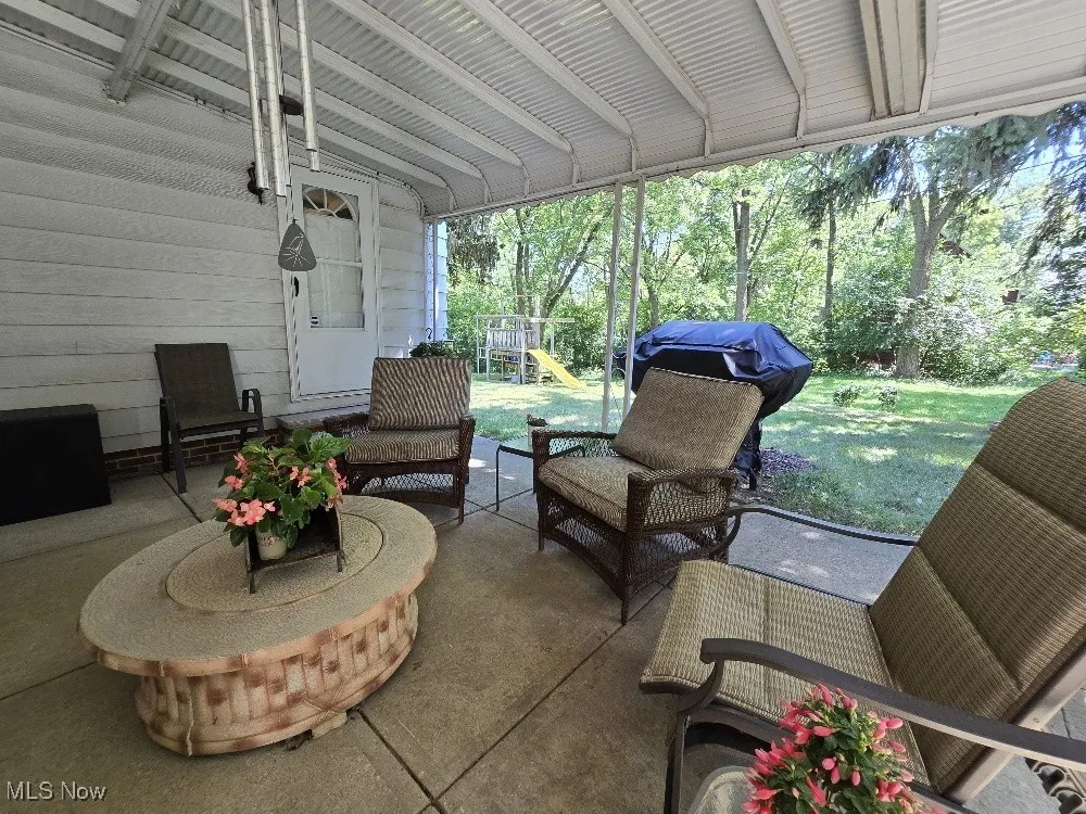 View of patio with a playground, an outdoor living space, and area for grilling