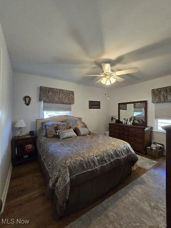 Bedroom with wood finished floors, a ceiling fan, and a textured ceiling