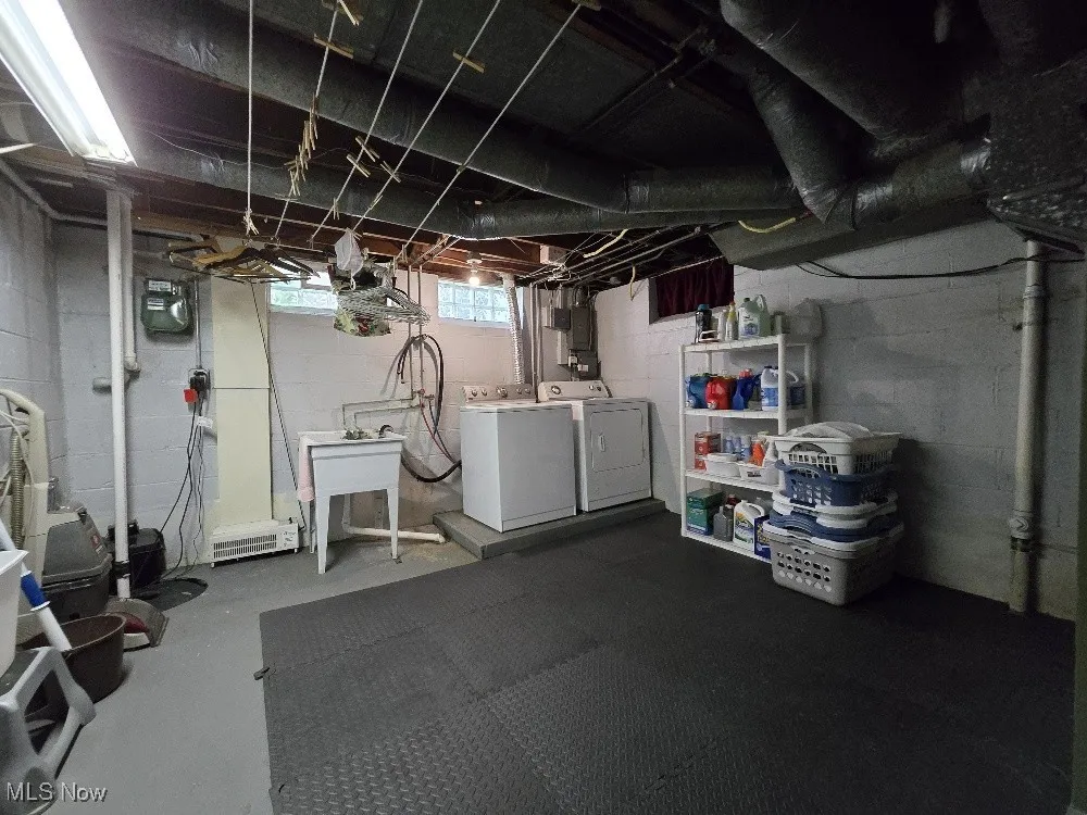 Basement featuring washing machine and dryer and gas meter