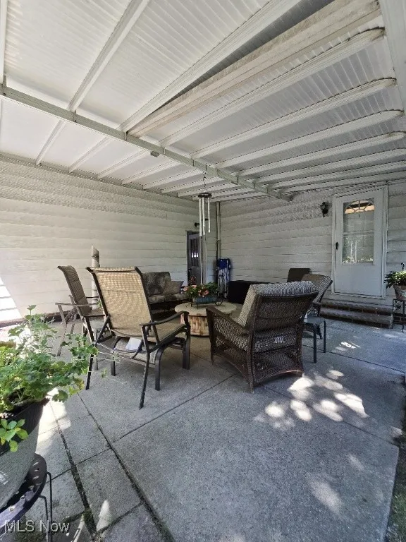View of patio with an outdoor hangout area
