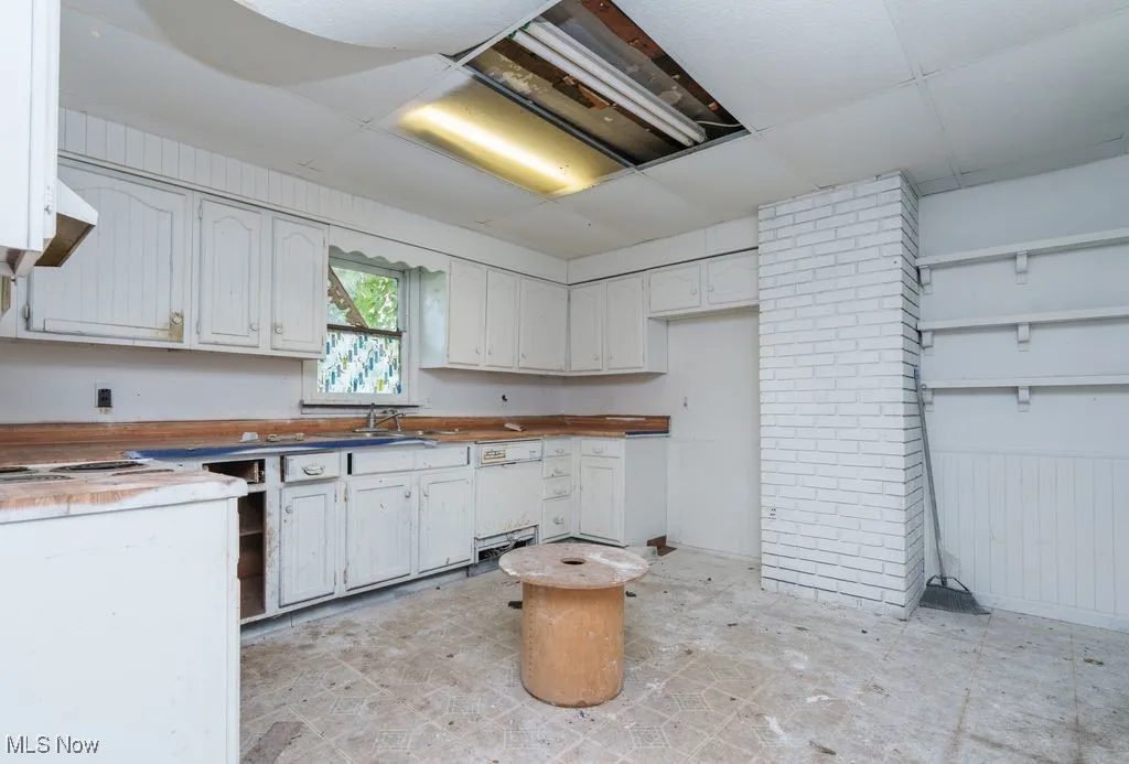 Kitchen featuring dishwasher and light flooring