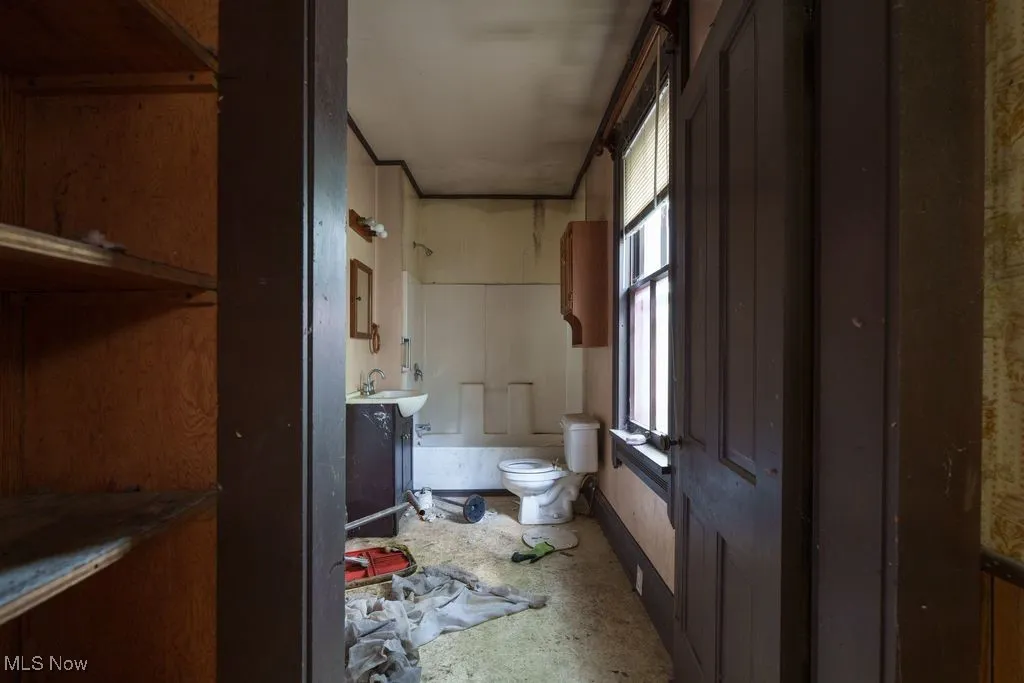 Full bath featuring toilet and a sink