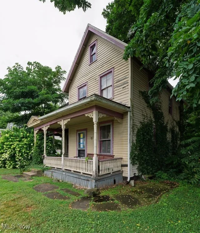 View of front of house featuring covered porch and a front yard