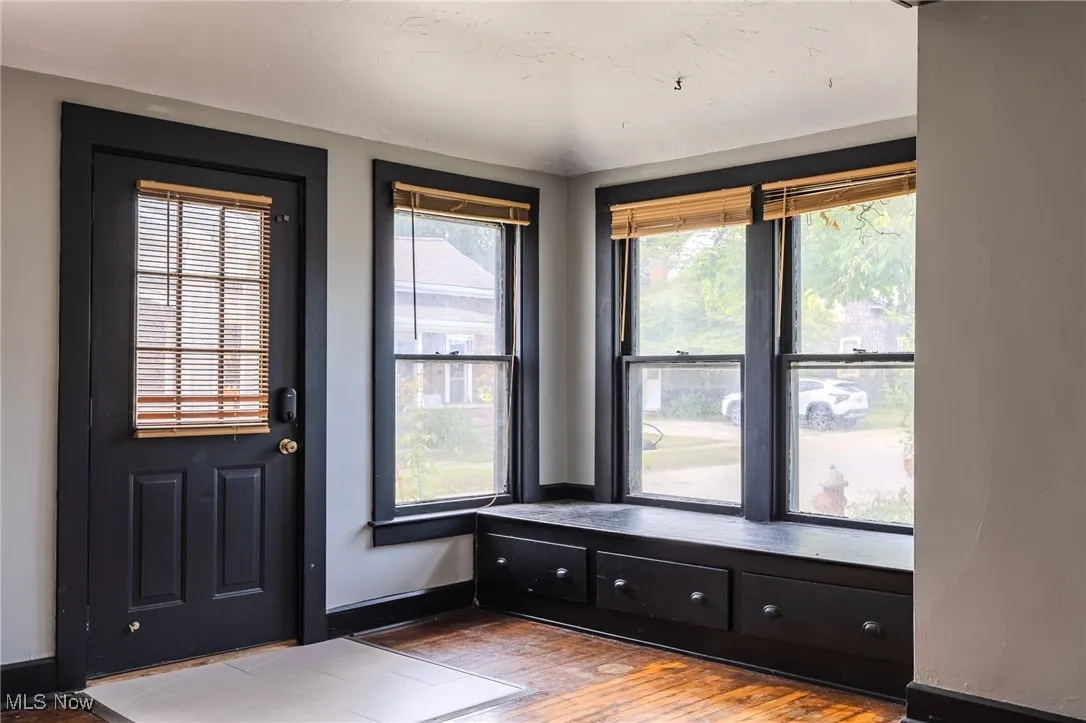 Foyer with wood finished floors and baseboards