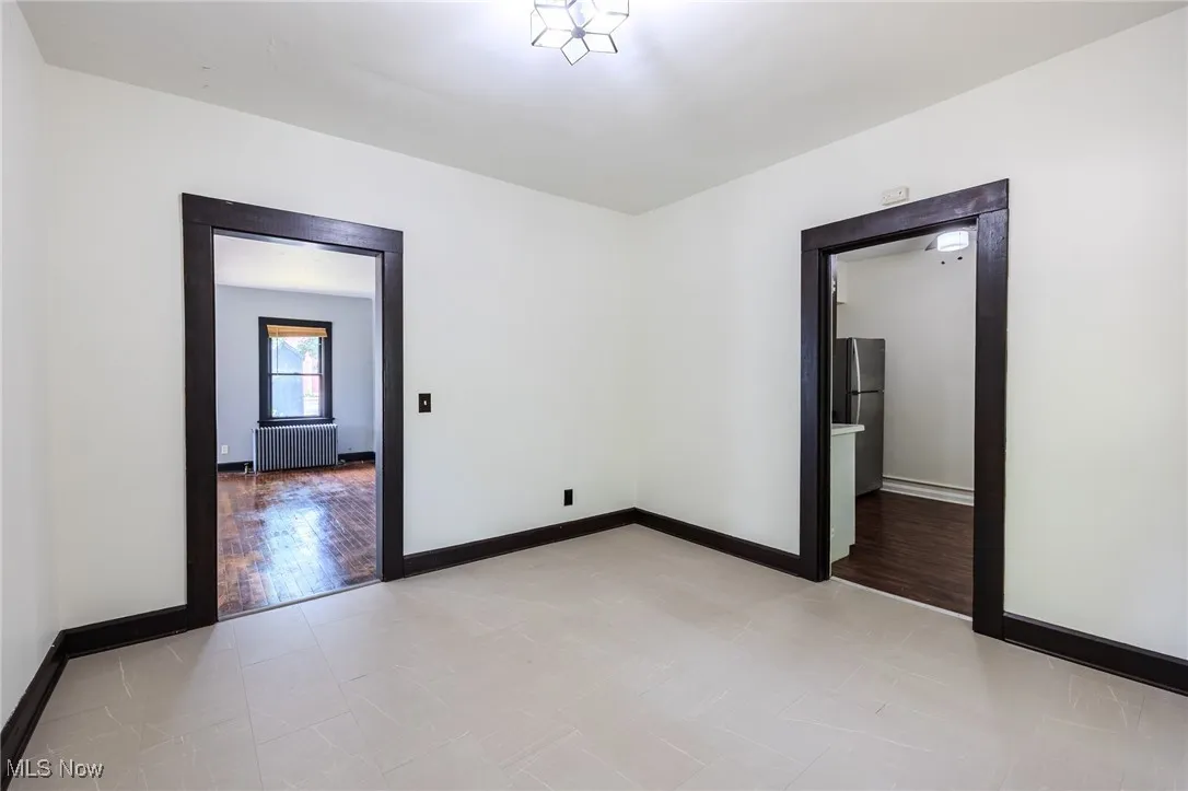 Spare room with radiator heating unit and light wood finished floors