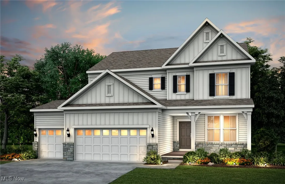 Farmhouse style exterior with stone wainscotting and covered front porch.