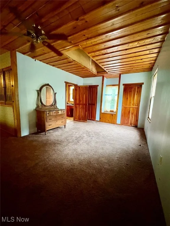 Bedroom featuring carpet, ceiling fan, and wood ceiling