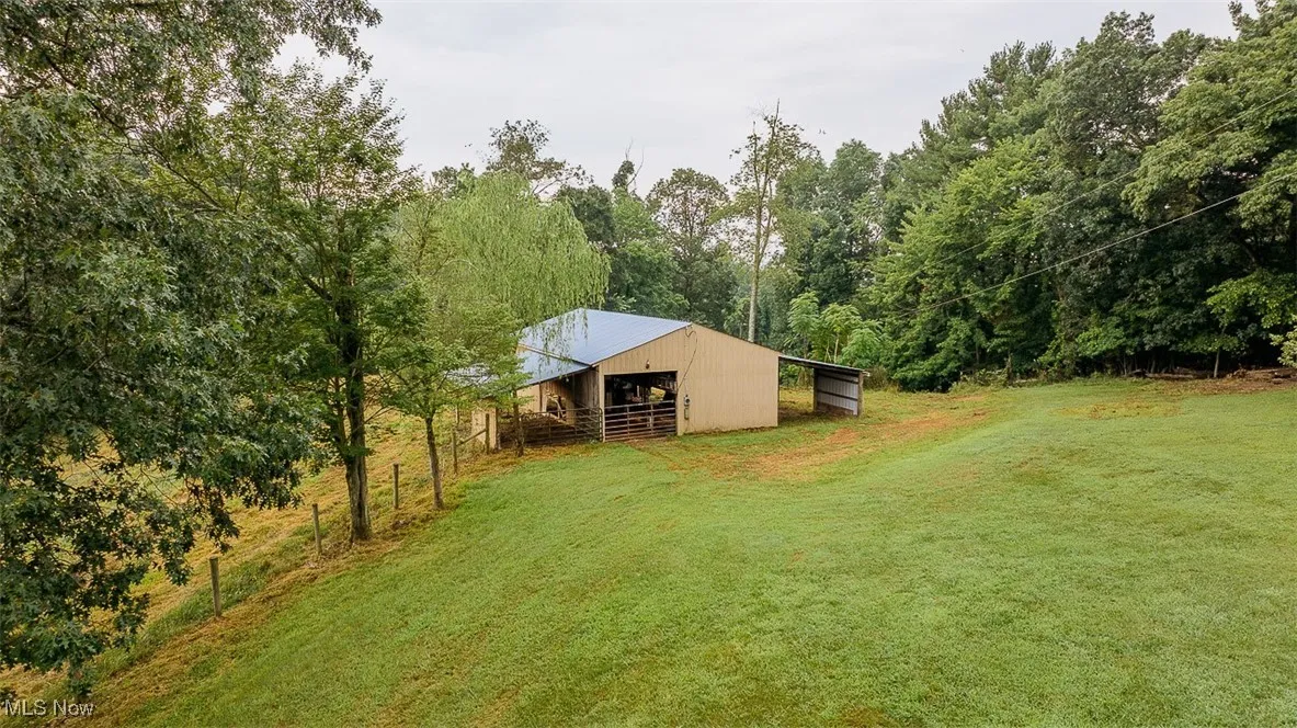 View of outbuilding, an exterior structure, and wooded view