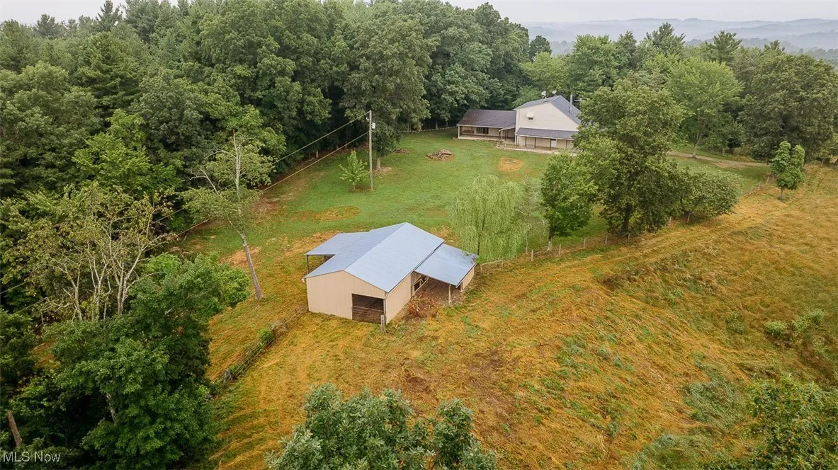 View from above of property with a heavily wooded area