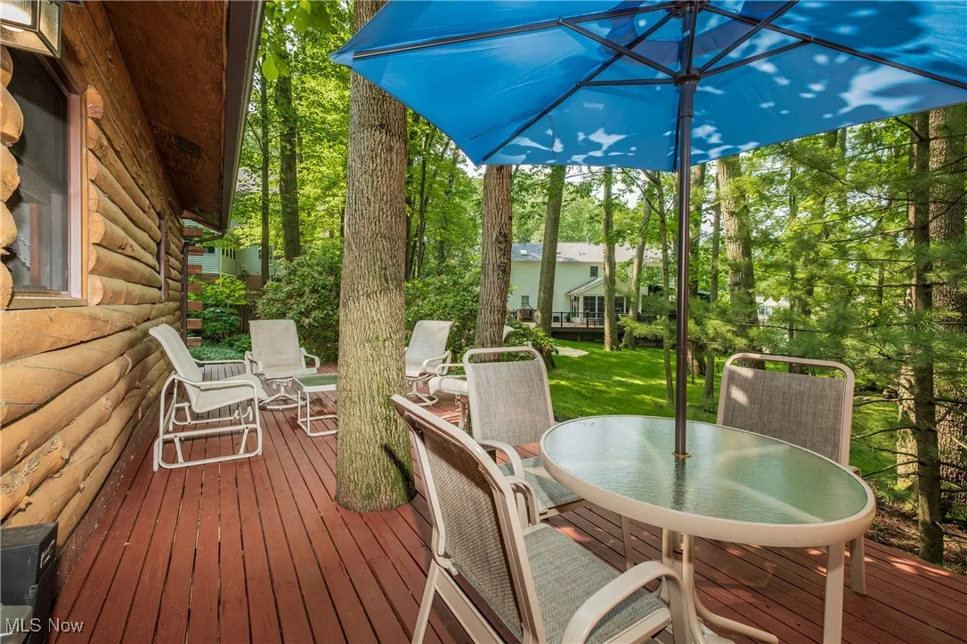 Wooden terrace featuring outdoor dining area