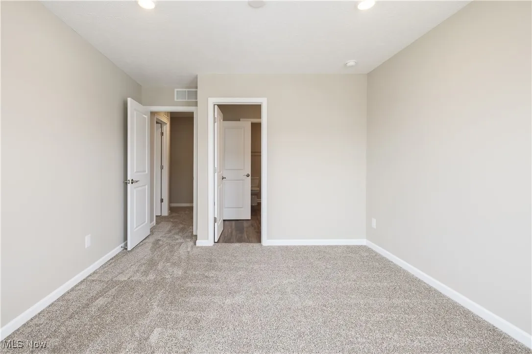 Unfurnished bedroom with carpet flooring and recessed lighting