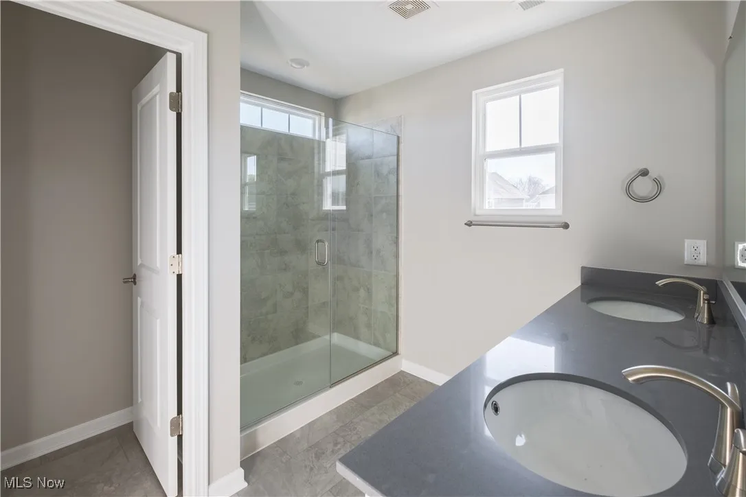 Full tiled, walk-in shower with frameless glass surround