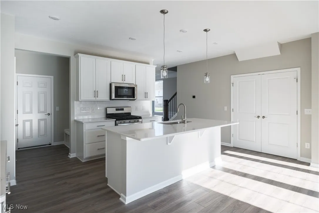 Open concept living area with upgrade white maple cabinetry