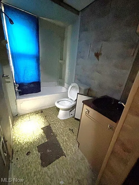 Bathroom with a tub to relax in, tile patterned floors, and vanity