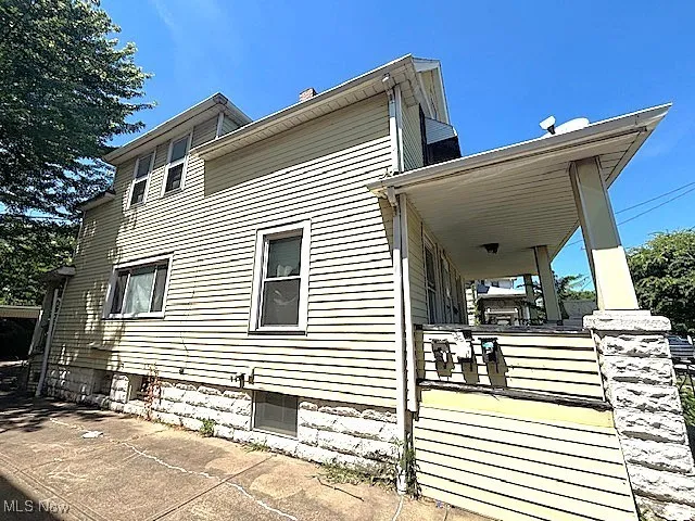 View of side of property with a porch