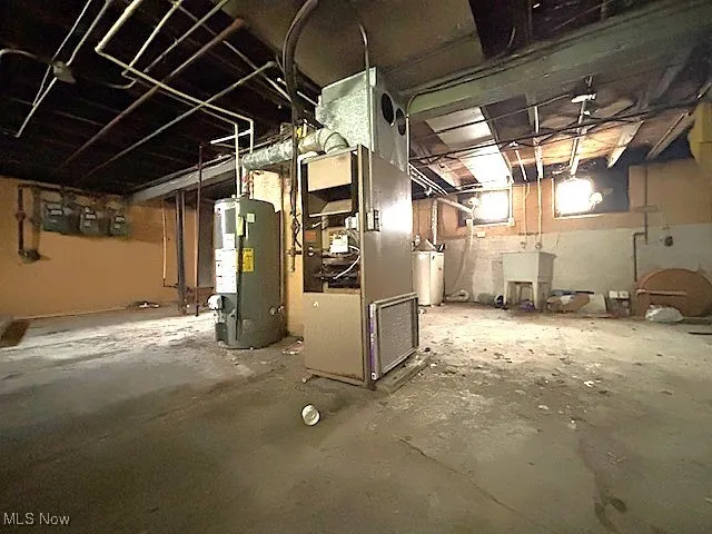 Unfinished basement with water heater and heating unit