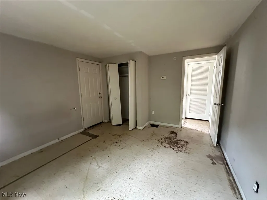 Unfurnished bedroom with baseboards and a closet