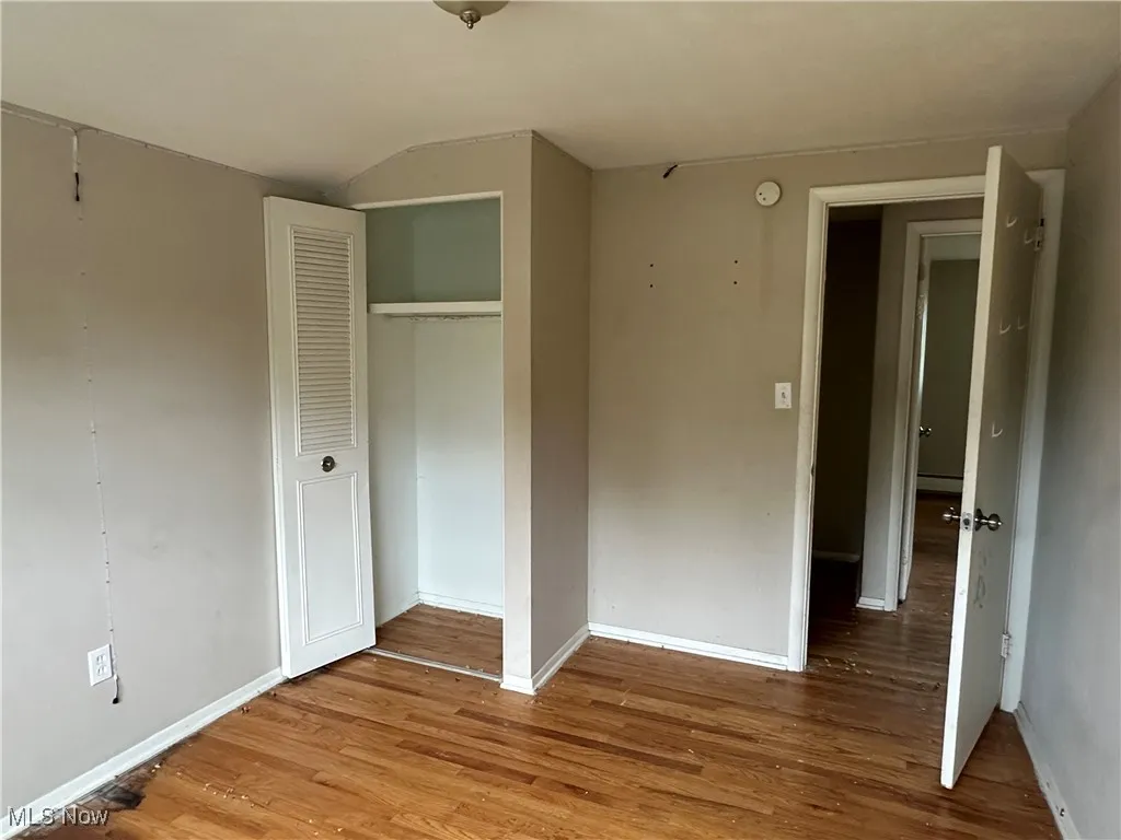 Unfurnished bedroom featuring light wood finished floors and a closet