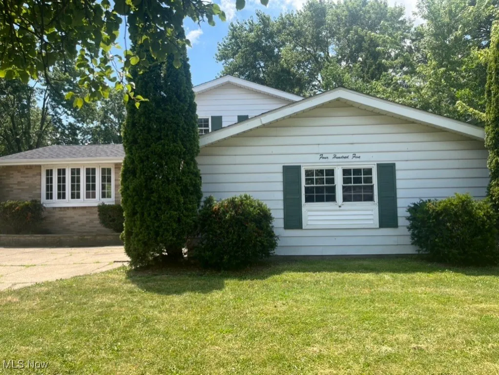 View of home's exterior featuring a yard and brick siding