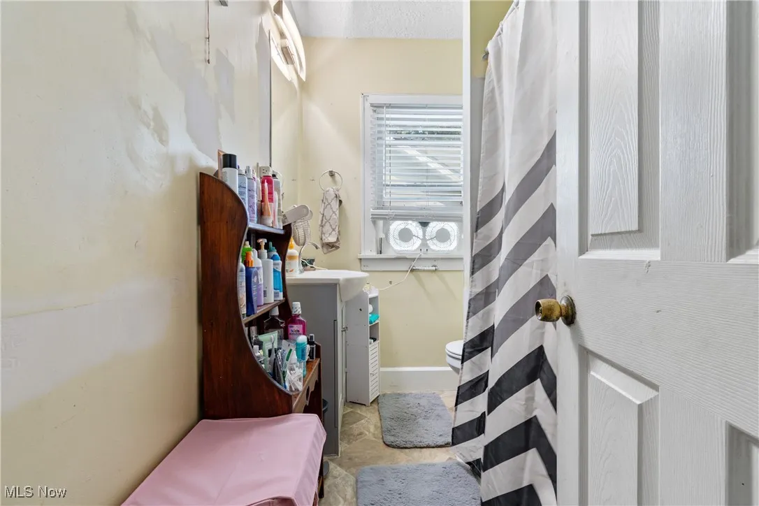 Full bathroom featuring vanity, a shower with curtain, and a textured ceiling