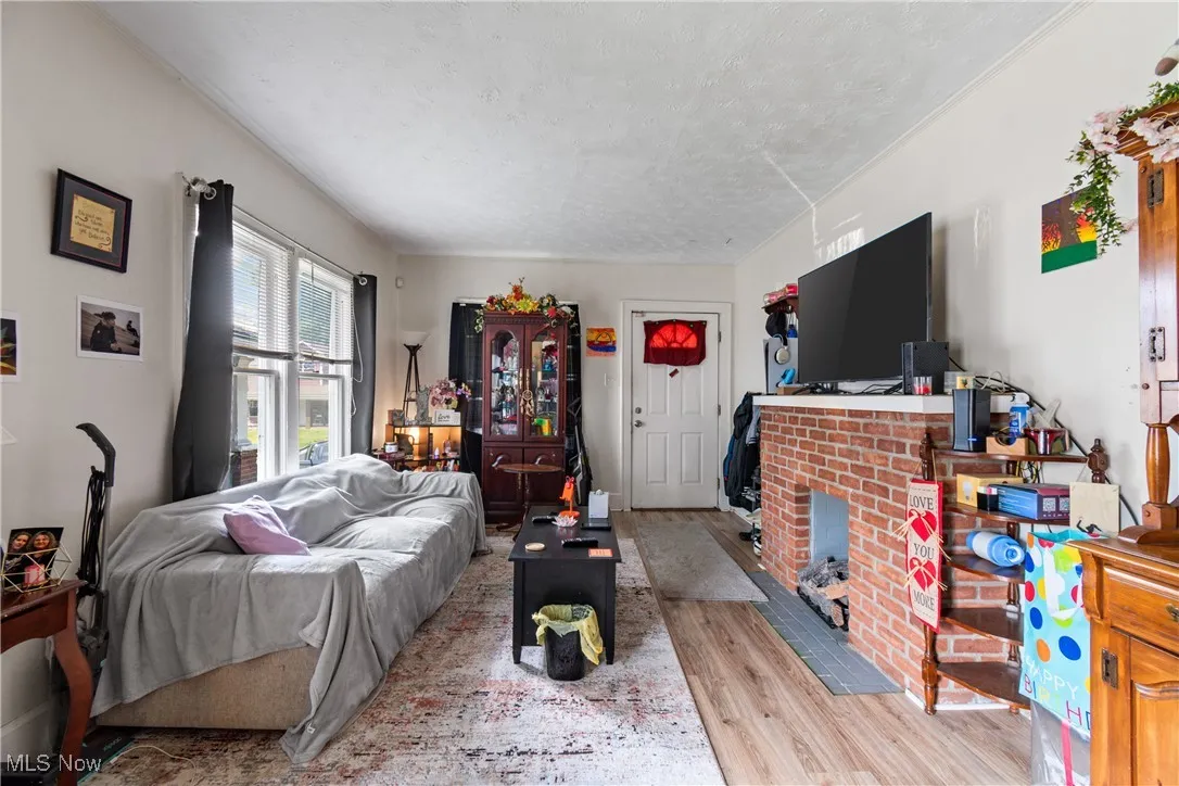 Living area featuring wood finished floors and a textured ceiling