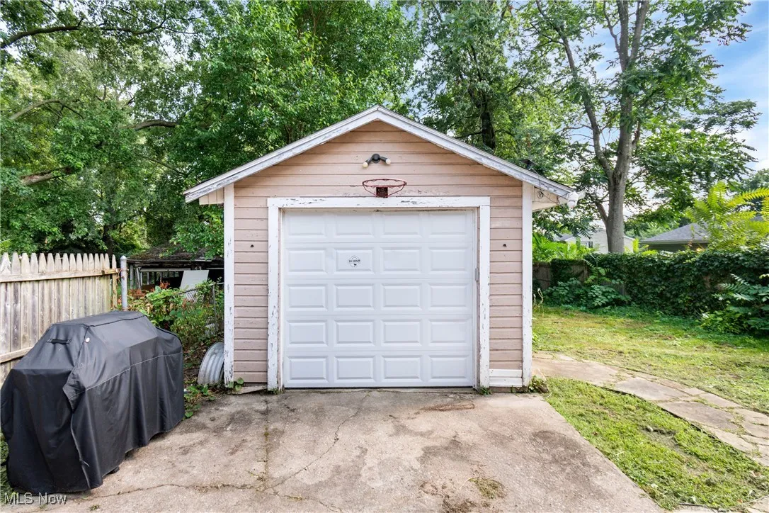 Detached garage featuring concrete driveway