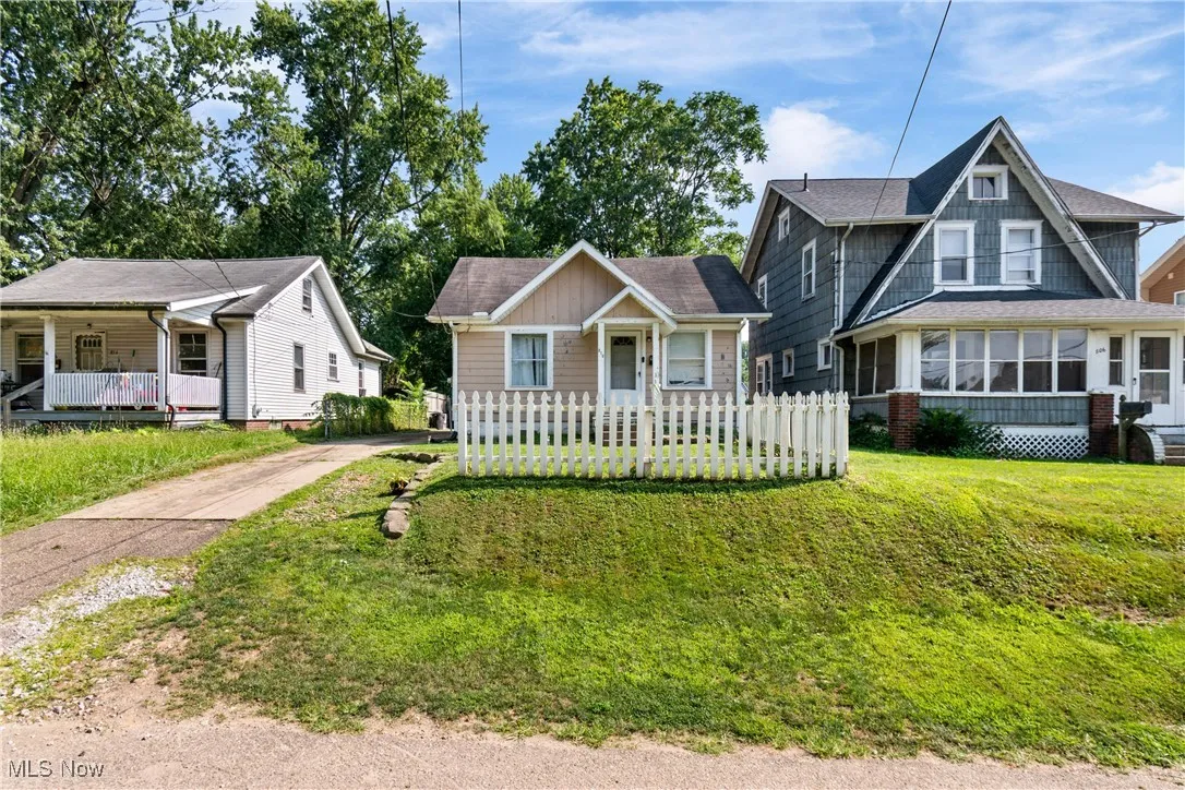 Bungalow-style house with covered porch, a shingled roof, and concrete driveway