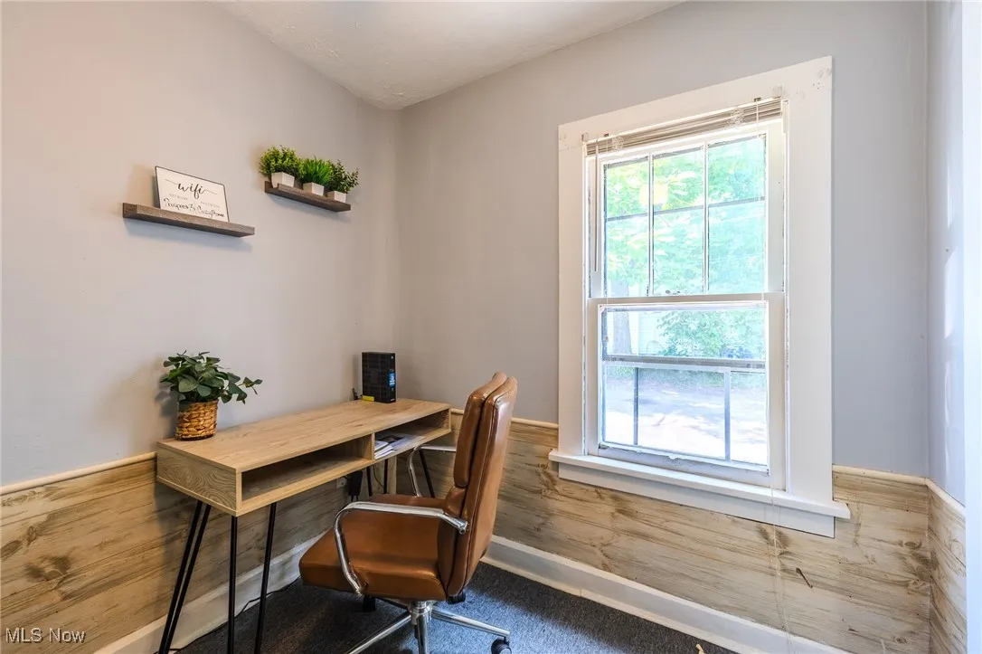 Office space featuring wainscoting and wood walls