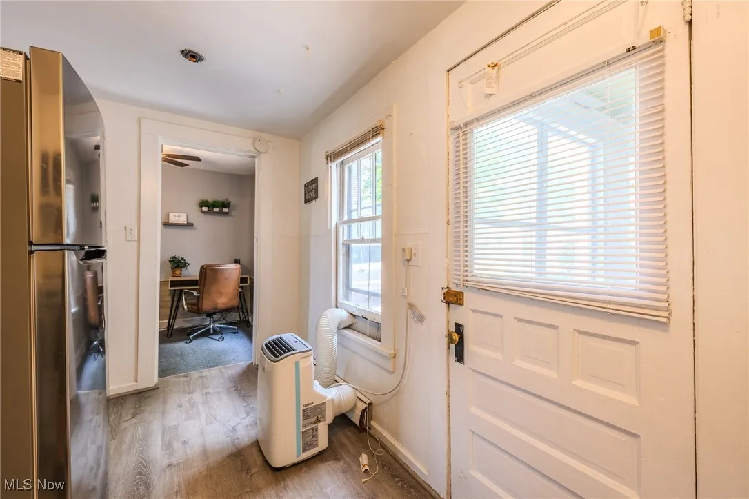 Entryway with light wood-type flooring and an office area