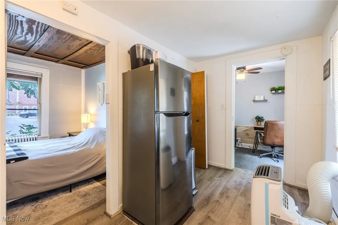 Kitchen featuring freestanding refrigerator, light wood-style flooring, and a ceiling fan