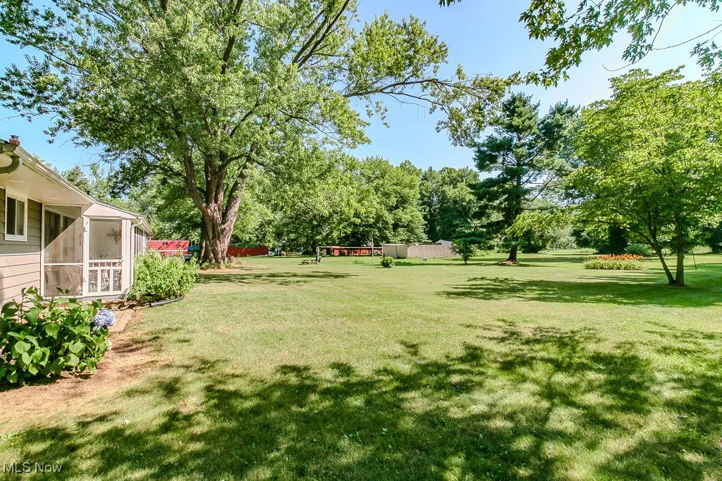 View of green lawn with a sunroom